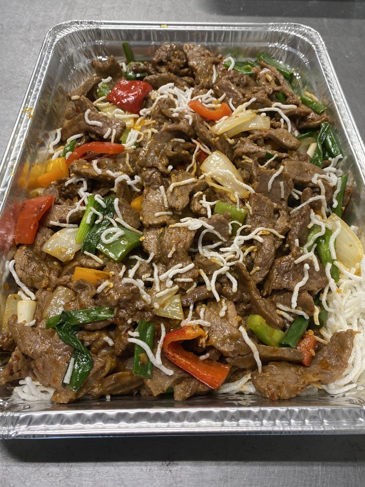 Full tray of Mongolian beef topped with crispy rice noodles